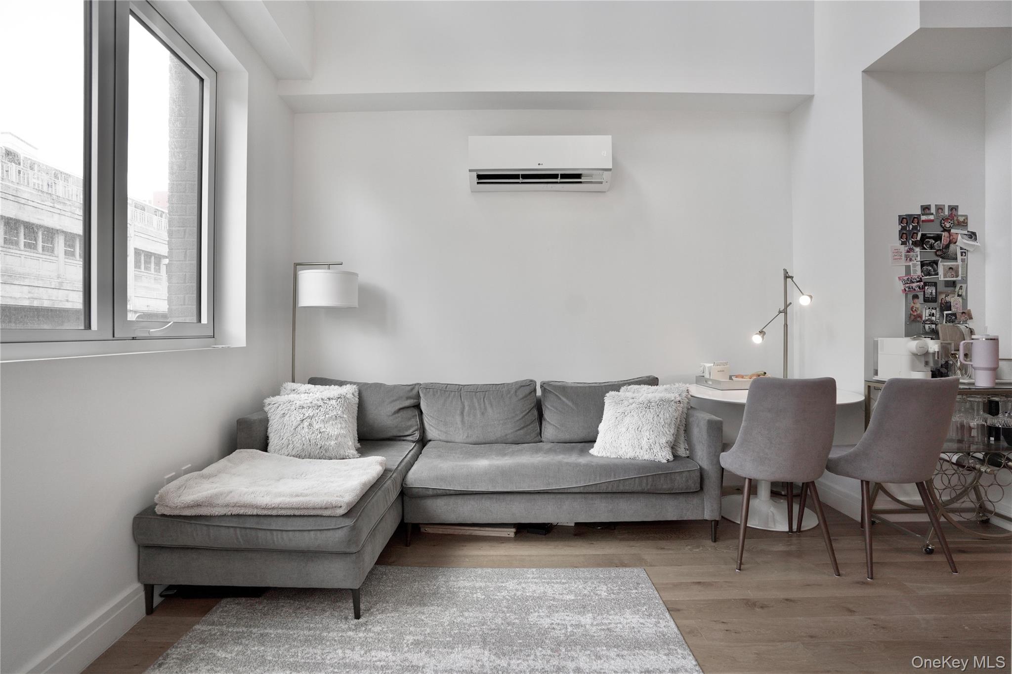 24-16 Queens Plaza South, Unit 2D Queens, NY 11101 - Photo 6 of 28 a living room with furniture and a window