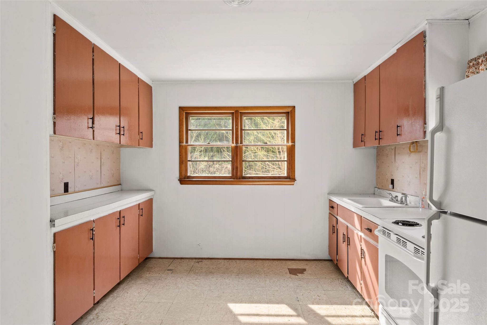 10999 Rush Fork Road Clyde, NC 28721 - Photo 15 of 38 a kitchen with a stove a sink and a refrigerator