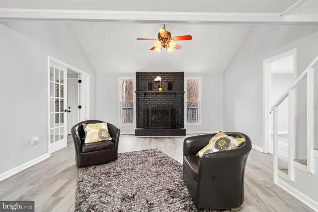 a bathroom with a granite countertop sink a toilet and a mirror
