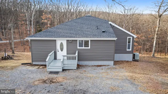 a white house with a large tree in front of it