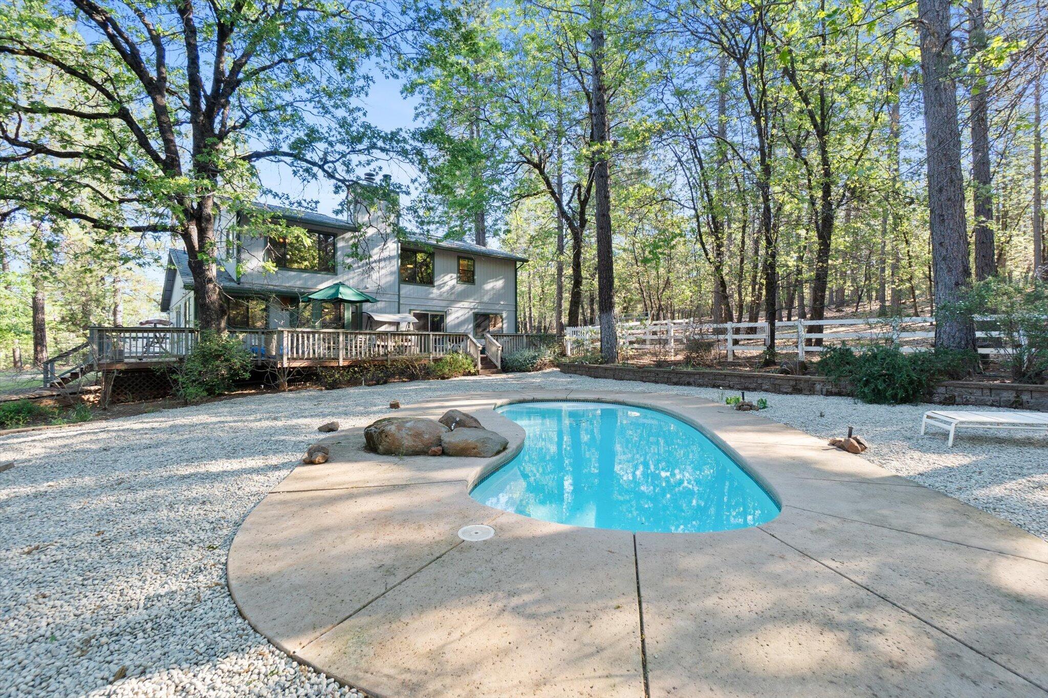 26997 Lookout Mountain Road Oak Run, CA 96069 - Photo 3 of 92 a swimming pool with outdoor seating and yard