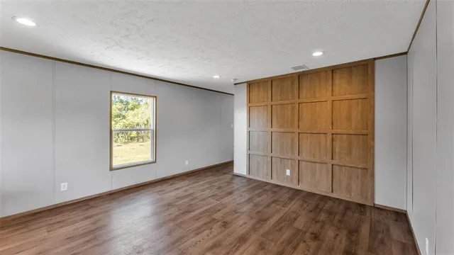 a view of hallway with wooden floor and stairs