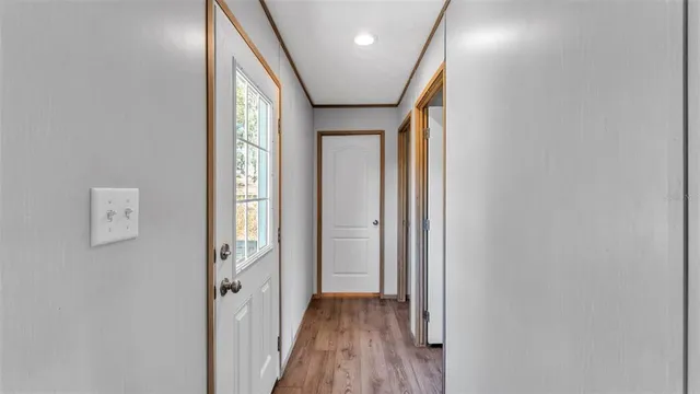 a large bedroom with a bed and a large window