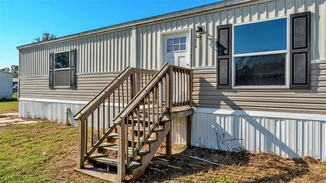 a view of a house with wooden floor roof and wooden fence