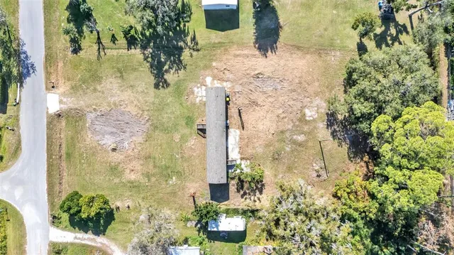 an aerial view of a house with a yard and lake view