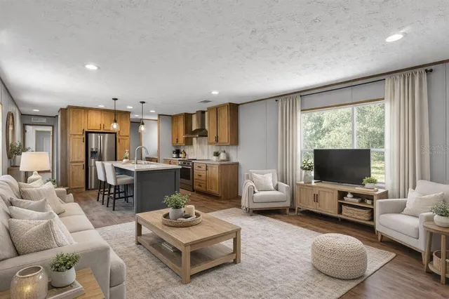 a living room with furniture a flat screen tv and a large window