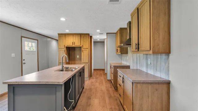 a kitchen with a sink a stove and cabinets