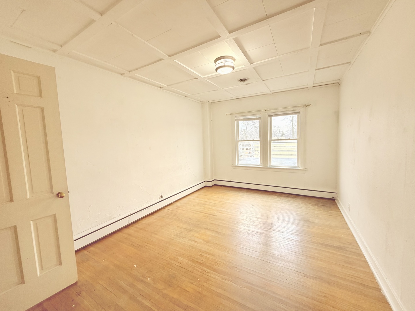 134 West State Street Sycamore, IL 60178 - Photo 31 of 43 an empty room with wooden floor and windows