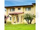 1446 56th Street West, Unit 1446 Bradenton, FL 34209 - Photo 1 of 1 a view of a white house with a big yard and plants