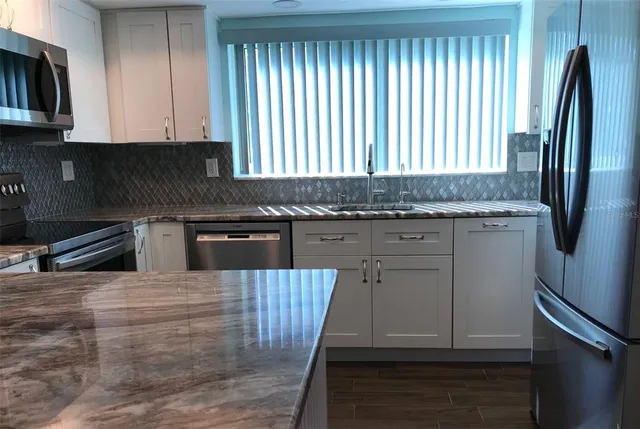 a stove top oven sitting inside of a kitchen