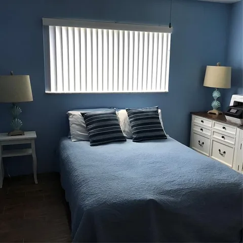 a bedroom with a bed and dresser