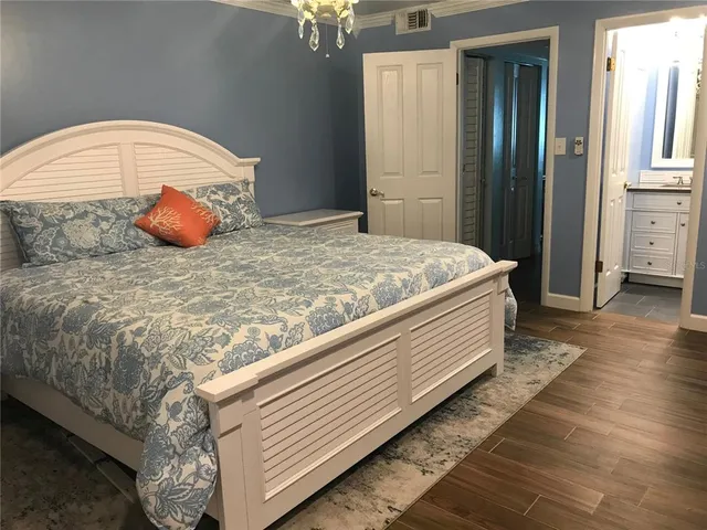 a bathroom with a sink a toilet a window and vanity