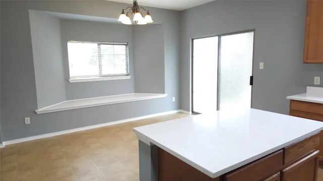 a view of a dining room with a table chairs and chandelier