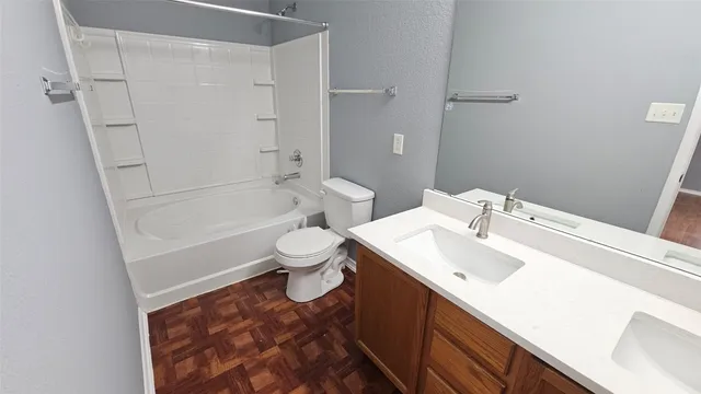 a bathroom with a sink toilet vanity and shower