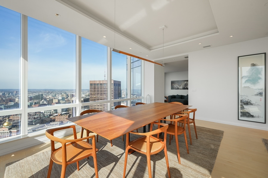 1 Franklin Street, Unit 4802 Boston, MA 02110 - Photo 8 of 42 a view of a dining room and livingroom with furniture window and wooden floor