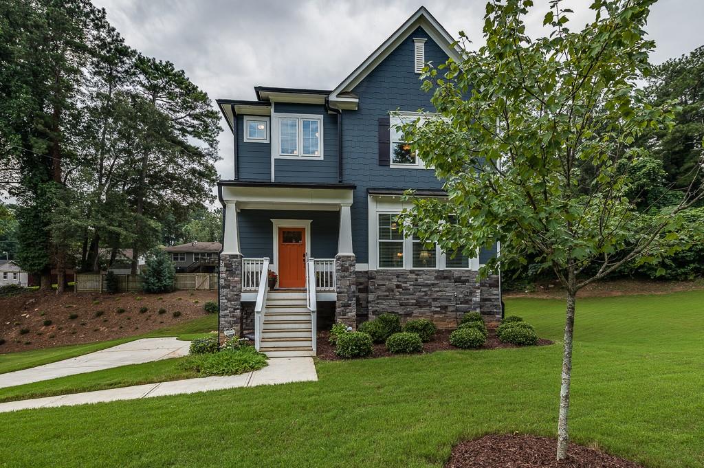 a front view of a house with a garden