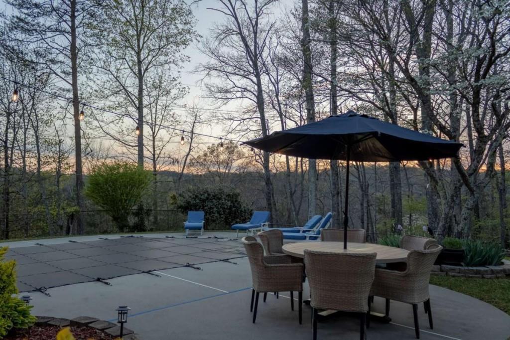 141 Chambers Mountain Road Mineral Bluff, GA 30559 - Photo 12 of 65 a view of backyard with table and chairs under an umbrella