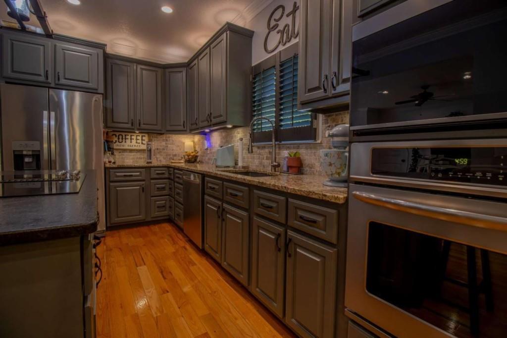 141 Chambers Mountain Road Mineral Bluff, GA 30559 - Photo 46 of 65 a kitchen with stainless steel appliances granite countertop a refrigerator a stove and a sink