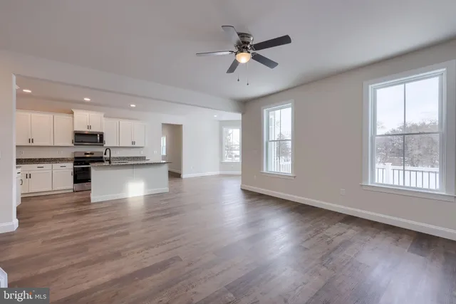 a view of kitchen with refrigerator microwave and stove