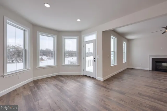 a view of kitchen and hall with wooden floor
