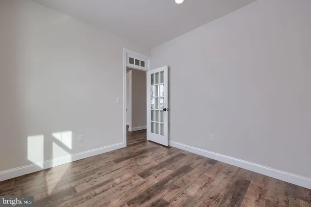 a view of a livingroom with wooden floor and a ceiling fan