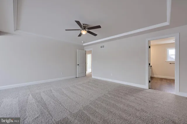 a spacious bathroom with double vanity a mirror and a shower