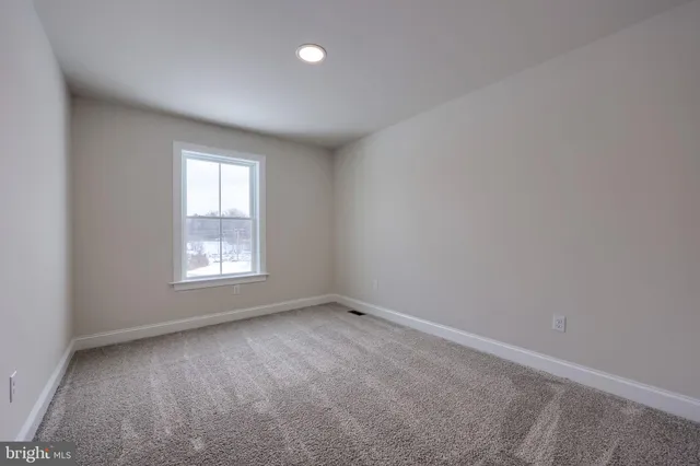 a spacious bathroom with a double vanity sink a mirror and a toilet