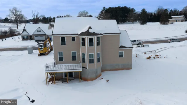 an aerial view of a house with a yard and lake view