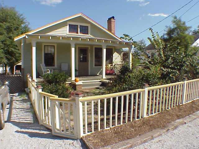 a front view of house with deck and yard