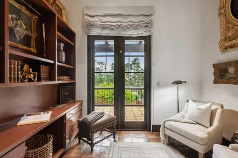 a livingroom with workspace and a couch