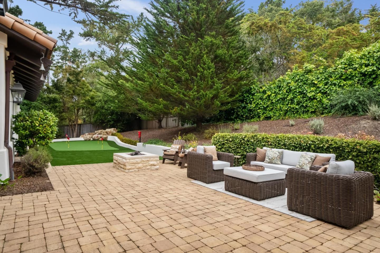 1425 Oleada Road Pebble Beach, CA 93953 - Photo 28 of 39 a view of a patio with couches and a table and chairs with garden