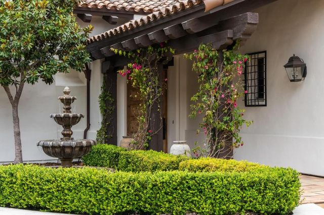 a view of a house with a flower garden