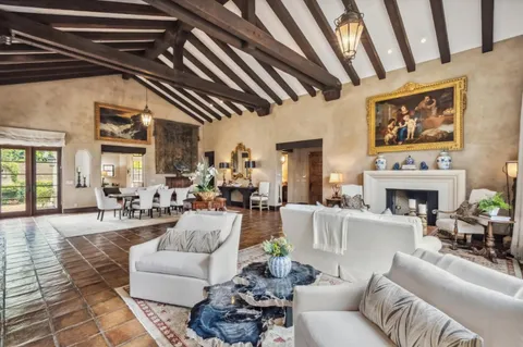 a living room with furniture a fireplace and a table