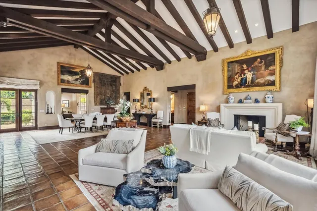 a living room with furniture a fireplace and a table