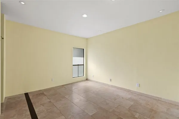 an empty room with windows and closet