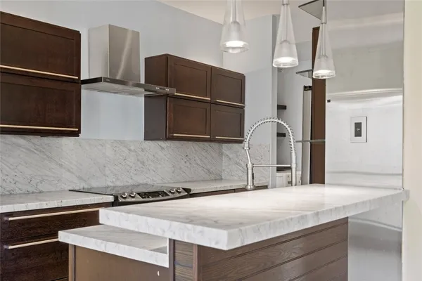 a kitchen with stainless steel appliances granite countertop a sink and a refrigerator