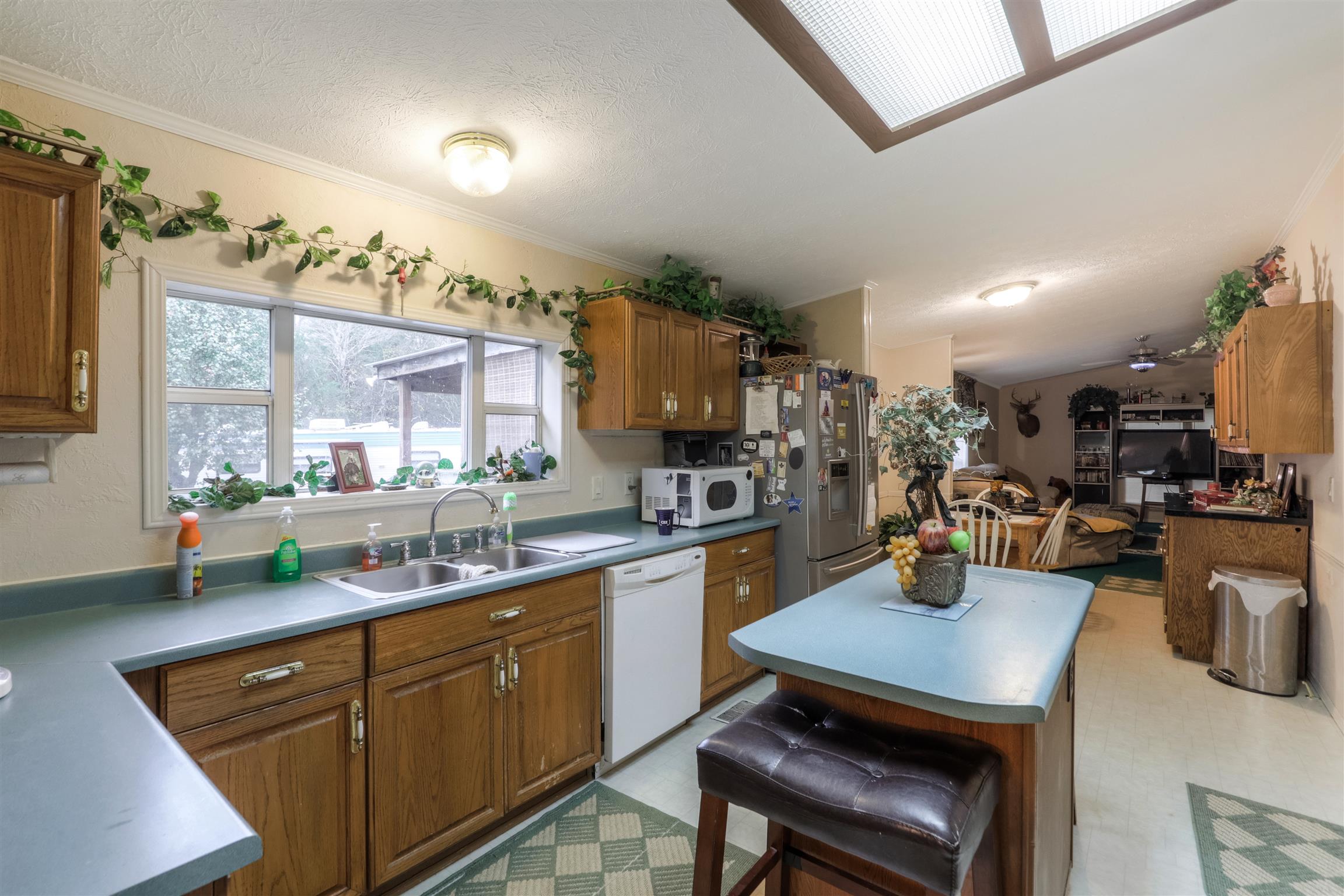 2981 Simmons Bluff Road Lebanon, TN 37090 - Photo 6 of 25 a kitchen with a sink a stove and chairs