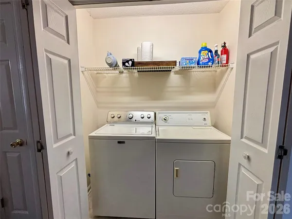 a view of washer and dryer with bathtub
