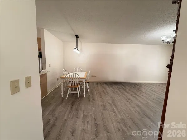 a view of a room with wooden floor