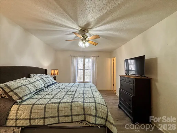 a bedroom with a bed and a television