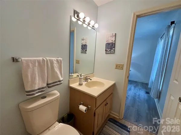 a bathroom with a sink toilet and mirror