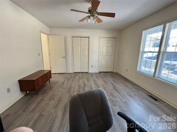 a view of workspace room with wooden floor and windows