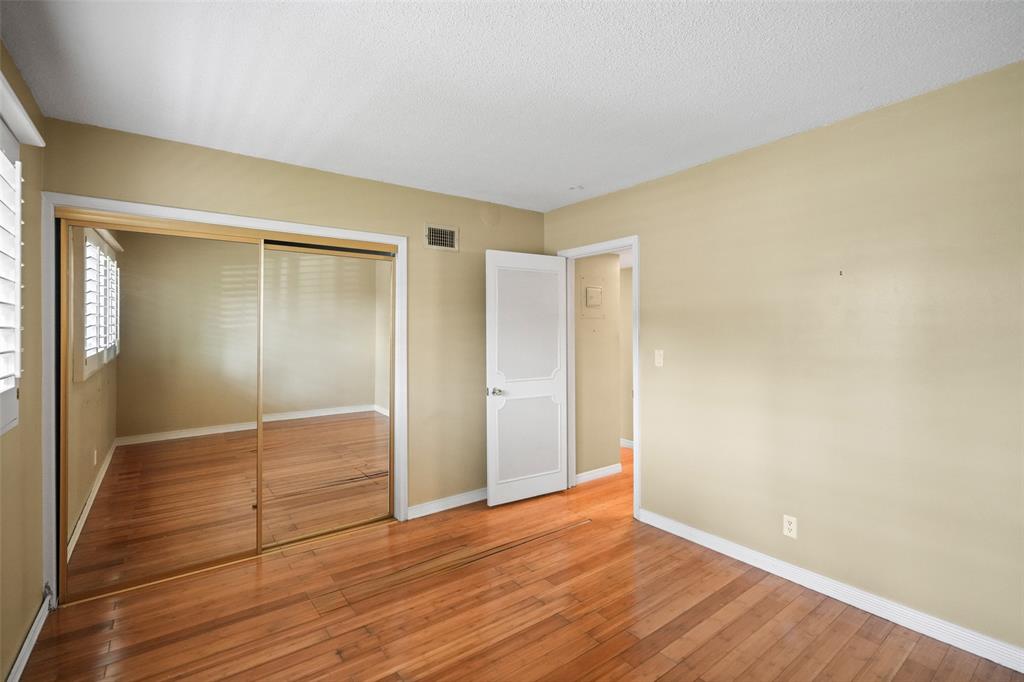 1100 Pine Drive, Unit 107 Pompano Beach, FL 33060 - Photo 21 of 40 a view of empty room with wooden floor