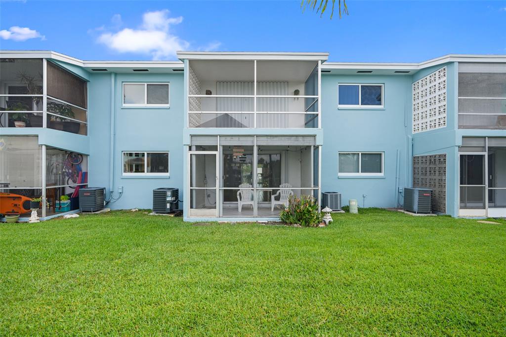 1100 Pine Drive, Unit 107 Pompano Beach, FL 33060 - Photo 33 of 40 a view of a house with a yard and sitting area