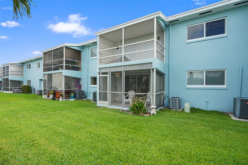 1100 Pine Drive, Unit 107 Pompano Beach, FL 33060 - Photo 35 of 40 a backyard of a house with table and chairs