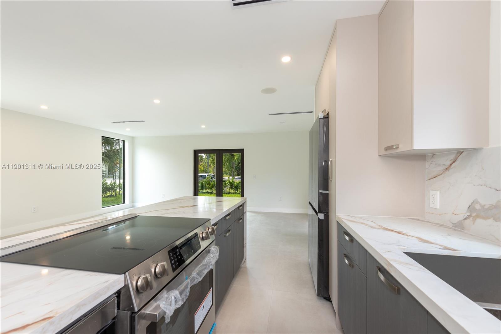 101 Southwest 25th Road Miami, FL 33129 - Photo 12 of 35 a kitchen with stainless steel appliances granite countertop a sink and a stove