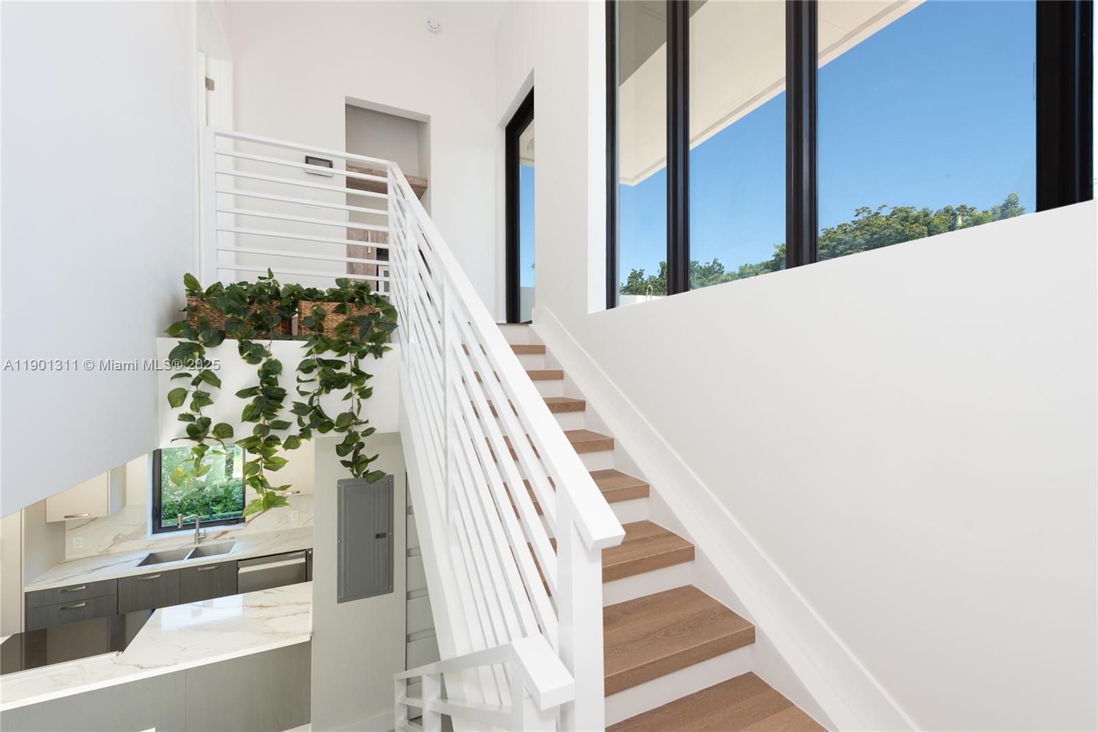 101 Southwest 25th Road Miami, FL 33129 - Photo 15 of 35 a view of staircase with white walls and a potted plant
