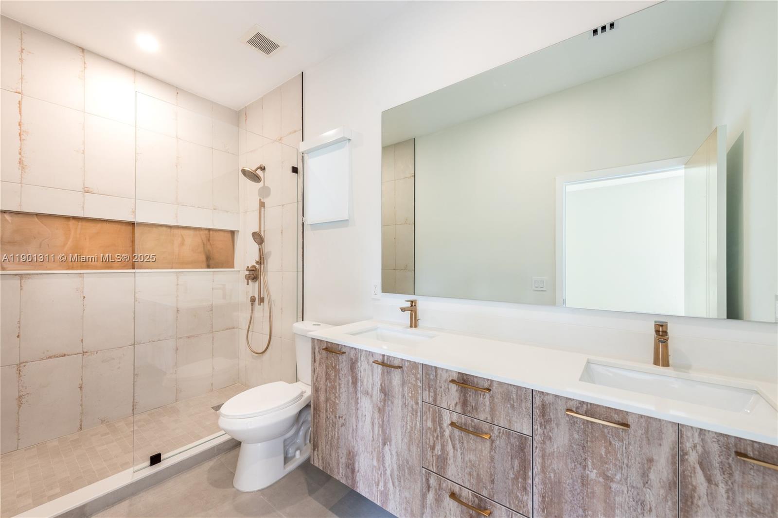 101 Southwest 25th Road Miami, FL 33129 - Photo 25 of 35 a bathroom with a sink a toilet and shower