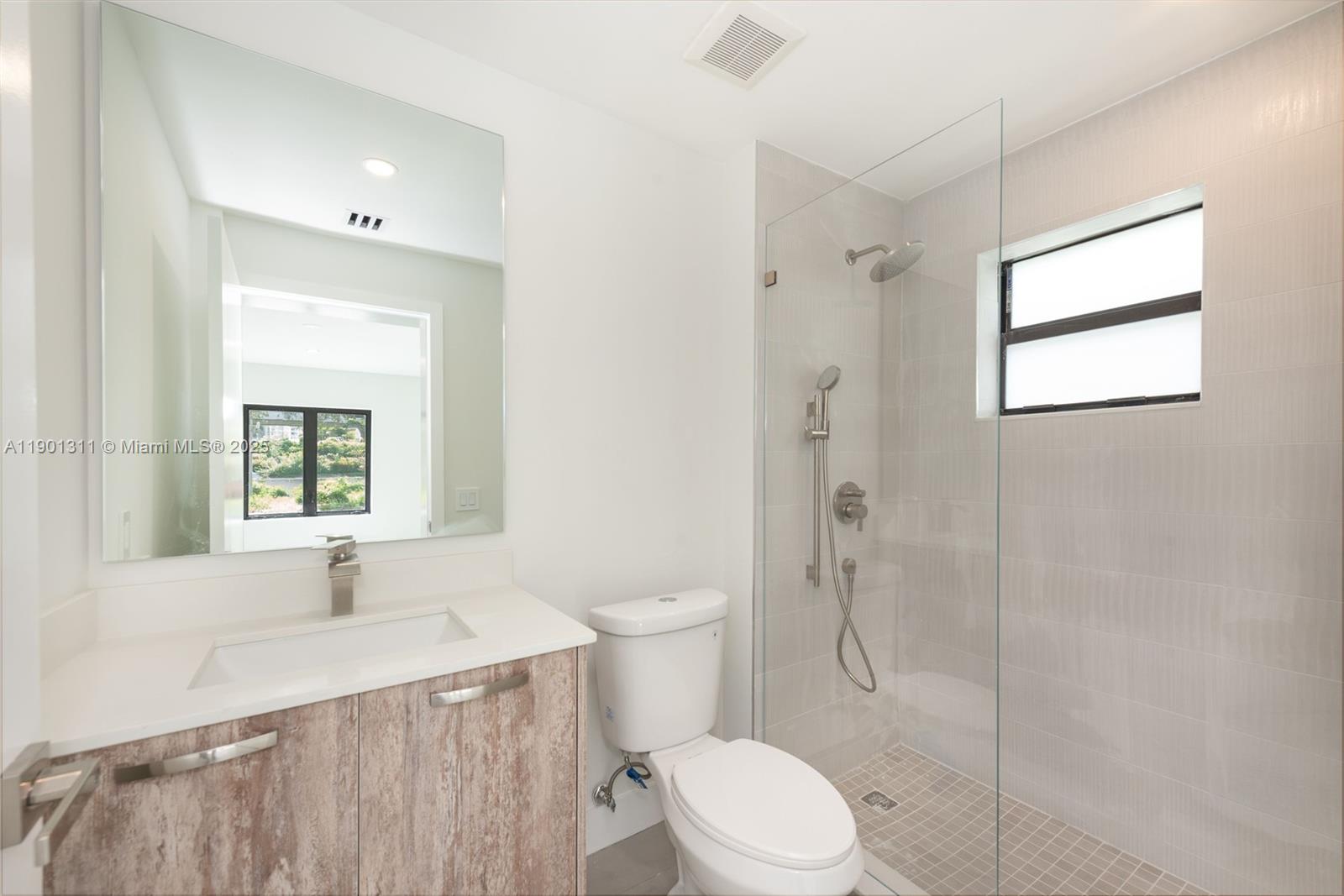 101 Southwest 25th Road Miami, FL 33129 - Photo 30 of 35 a bathroom with a sink a toilet and shower