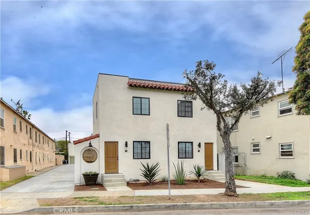 a front view of a house with garden